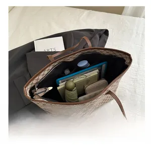 Detailed interior of a brown monogram tote bag showcasing high capacity for daily items