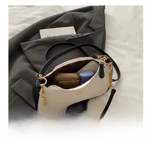 Internal view of the large capacity crossbody bag showing phone and wallet storage