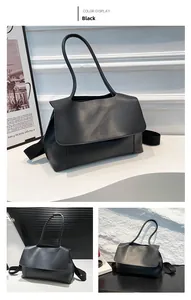 Detail view of black matte leather tote bag with elegant flap design and wide shoulder strap