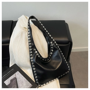 Detail of silver rivets on black leather Hobo bag with elegant soft texture design