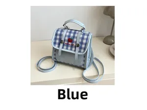 Close-up of blue plaid multi-functional handbag featuring apple embroidery and clear pocket