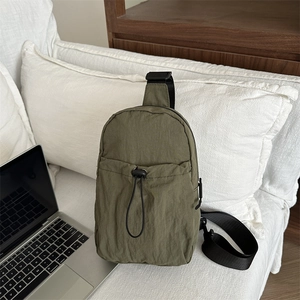 Olive green nylon crossbody chest bag with adjustable strap and front drawstring pocket