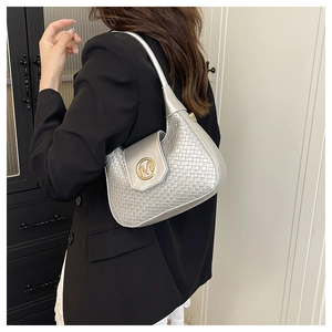 Detail of silver woven hobo bag featuring a gold 'M' logo and metallic finish