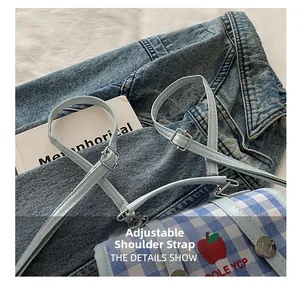 Detail of adjustable blue leather shoulder strap with silver buckle on checkered bag