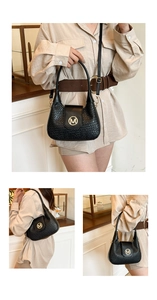 Detail of black woven shoulder bag with gold M-logo and fine textured craftsmanship
