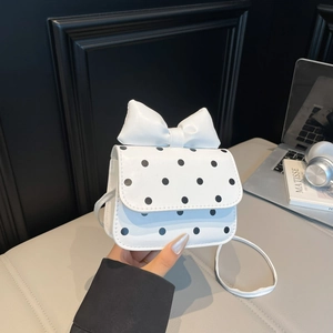 Chic white mini crossbody bag with black polka dots and a large bow decoration