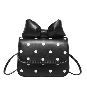 Mini black crossbody bag with white polka dots and a large decorative bow on top