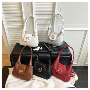 Detail showing five woven texture crescent bags in various colors with gold M buckle