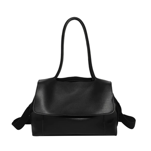 Minimalist black leather tote bag with long shoulder straps and flap closure design