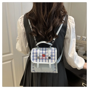 Mini blue plaid backpack detail featuring a cute red apple pattern on leather flap
