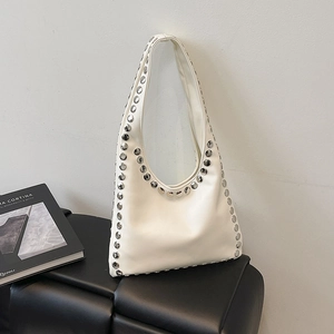 Chic beige shoulder tote bag with silver rivets and sleek faux leather finish