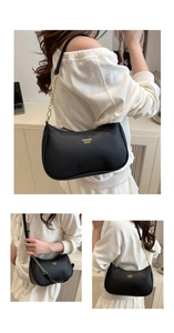 Close-up of black pebble leather texture and gold chain strap detail on a shoulder bag