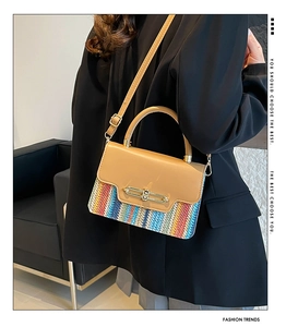 Detail of colorful woven texture and gold metal buckle on a stylish crossbody bag