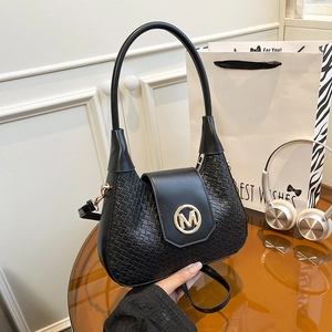 Large black woven shoulder bag with golden M logo and crescent shape for women