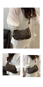 Detail view of brown monogram shoulder bag with gold chain and leather strap