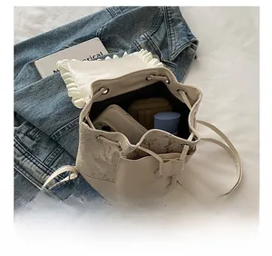 Internal capacity of mini white drawstring backpack with phone and cosmetics