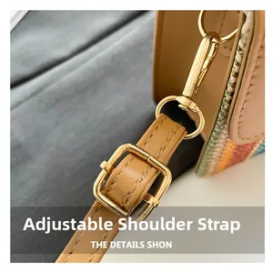 Detail of adjustable brown leather strap with polished gold buckle on woven crossbody bag