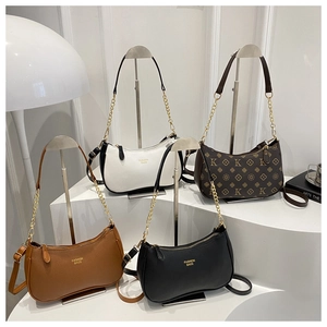 Minimalist leather shoulder bags shown in four distinct textures and neutral colors