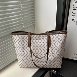 Classic patterned tote bag with brown leather handles and spacious interior