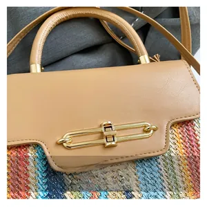 Close-up of beige leather and colorful woven fabric detail with golden metal lock