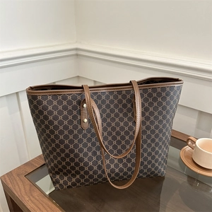 Classic coffee brown tote bag with vintage monogram pattern and leather handles