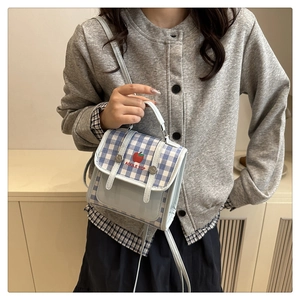 Detail of blue and white checkered mini crossbody bag with red apple embroidery