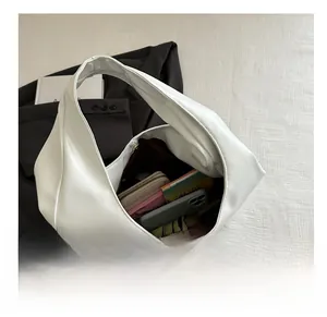 Top view of large white tote bag interior showing ample space for phone and books