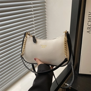Fashionable cream white crescent underarm bag with black contrast trim and gold chain
