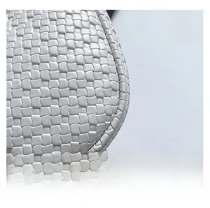 Detailed macro view of ivory white woven leather texture on a stylish baguette bag