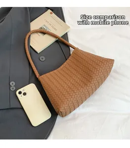 Detailed close-up of brown woven hobo bag showcasing intricate handicraft texture