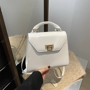 Minimalist white leather handbag for women featuring a golden rotating metal clasp and top handle