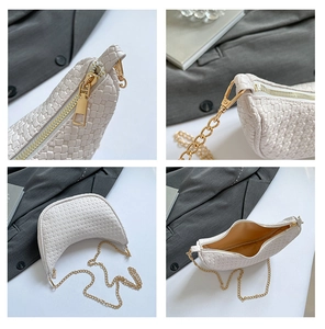 Macro details of white woven crescent bag featuring gold zipper and metal chain strap