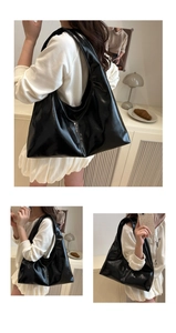 Detailed view of the glossy black hobo shoulder bag showing its texture and large capacity