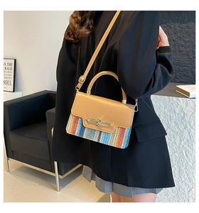 Detail of rainbow woven crossbody bag with tan leather flap and golden metal lock