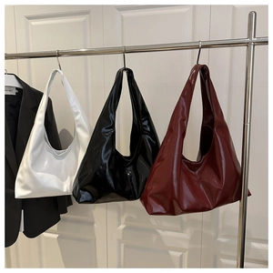 Detailed display of glossy hobo shoulder bags in white, black and burgundy finishes