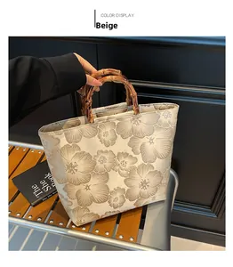 Detail of beige jacquard tote bag featuring retro floral patterns and bamboo handle