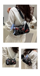 Detail of Y2K punk shoulder bag featuring star rivets and red heart patch accents
