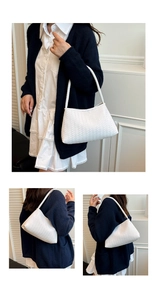 Detail of white woven hobo bag showing the intricate texture and minimalist crescent shape