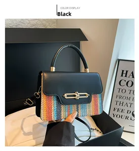 Close-up of elegant woven handbag featuring a gold metal twist lock on black leather flap