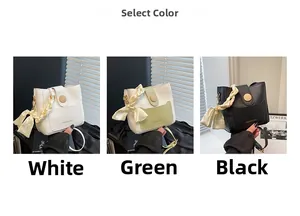 Detail of elegant bucket bag featuring wood-button closure and silk scarf handle decor