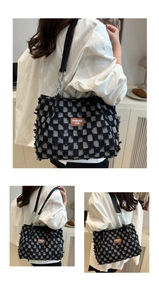 Detail of checkered denim tote featuring frayed edges and silver chain strap for women