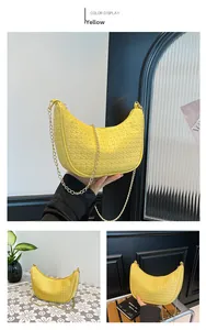 Detailed view of yellow woven crescent bag with gold chain strap for stylish women