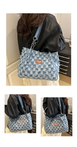 Detail of checkered denim tote bag featuring frayed edges and metal chain strap accents