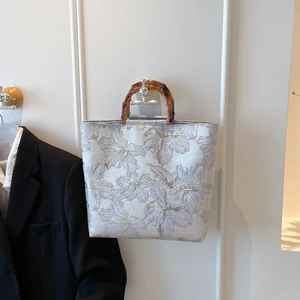 Floral embroidered canvas tote bag with bamboo handle and spacious interior