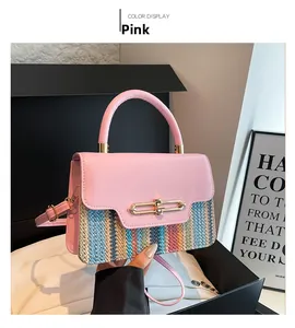 Detailed view of pink leather flap and multi-color woven texture on women's handbag