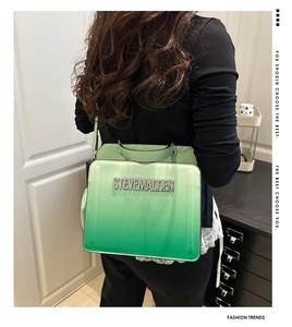 Detail of green gradient handbag featuring rhinestone Steve Madden logo on leather