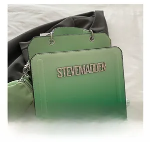 Detail showing gradient green faux leather handbag with rhinestone logo and mini charm pouch