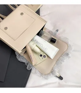 Detailed interior of a beige collegiate backpack showing large capacity for cosmetics and phone