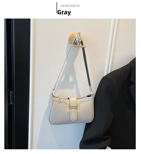 Detail der hellgrauen Hobo-Tasche mit goldener H-Schnalle und glattem Kunstlederfinish