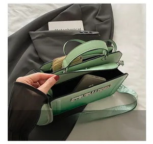 Top view of green gradient bag interior showing spacious compartments for phone and wallet